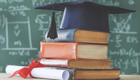 Books with a diploma and cap on them